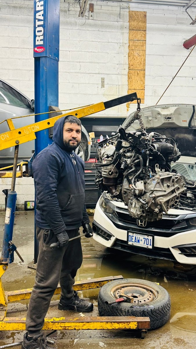 Khan working on an engine pull at the shop on Midland Ave