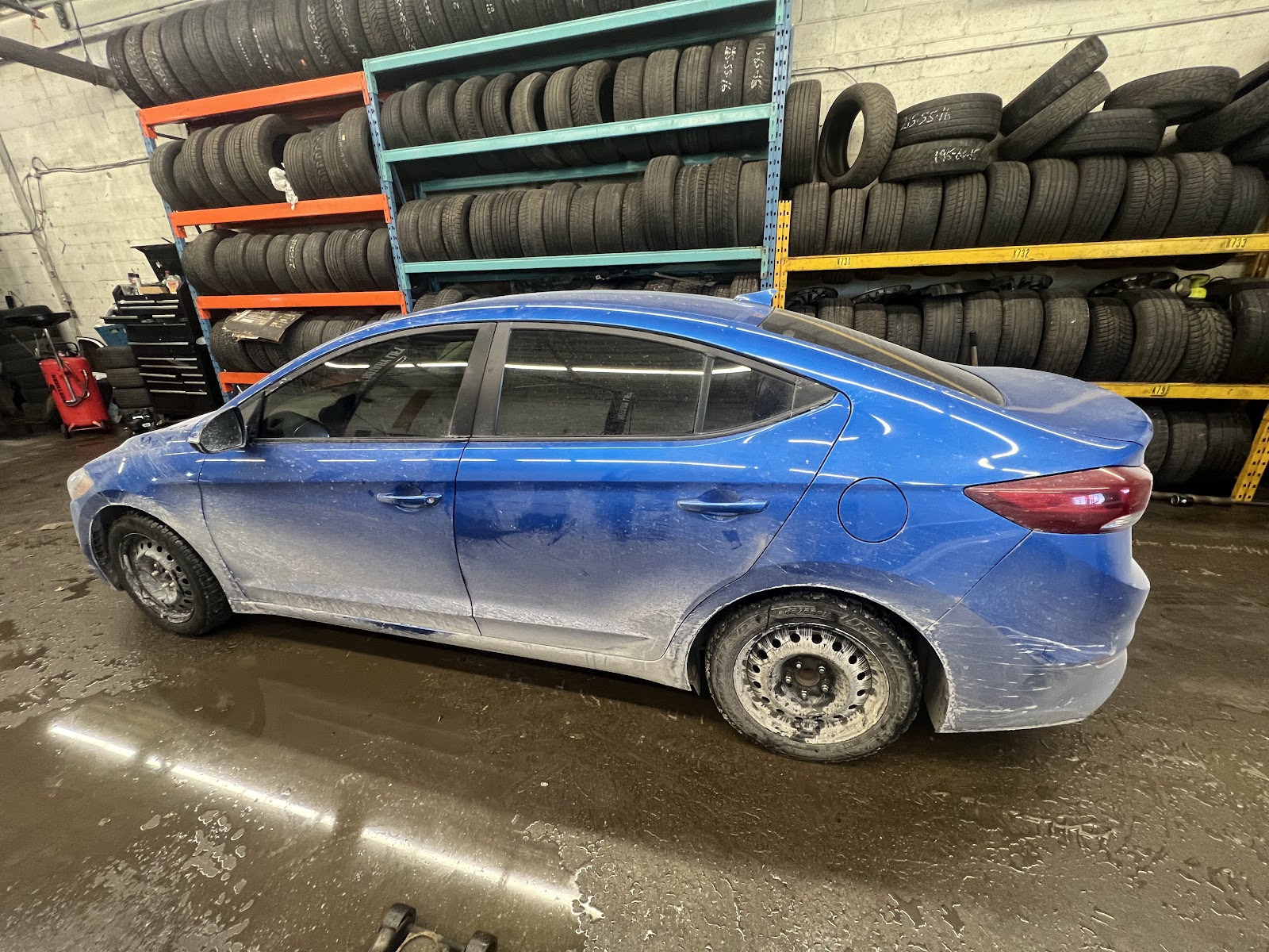 Mechanic finishing up an engine job at Khan Autos